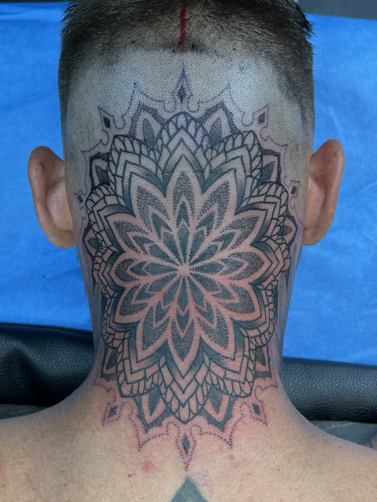 Mandala tattoo on the back of the head and neck